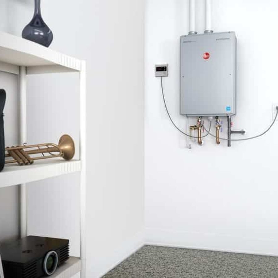 Watkins Plumbing Inc. technician installing a tankless water heater